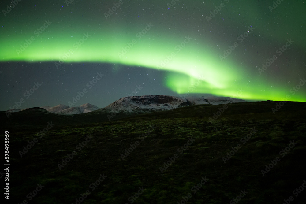 Aurora borealis over mountain landscape near Reykjavik Iceland