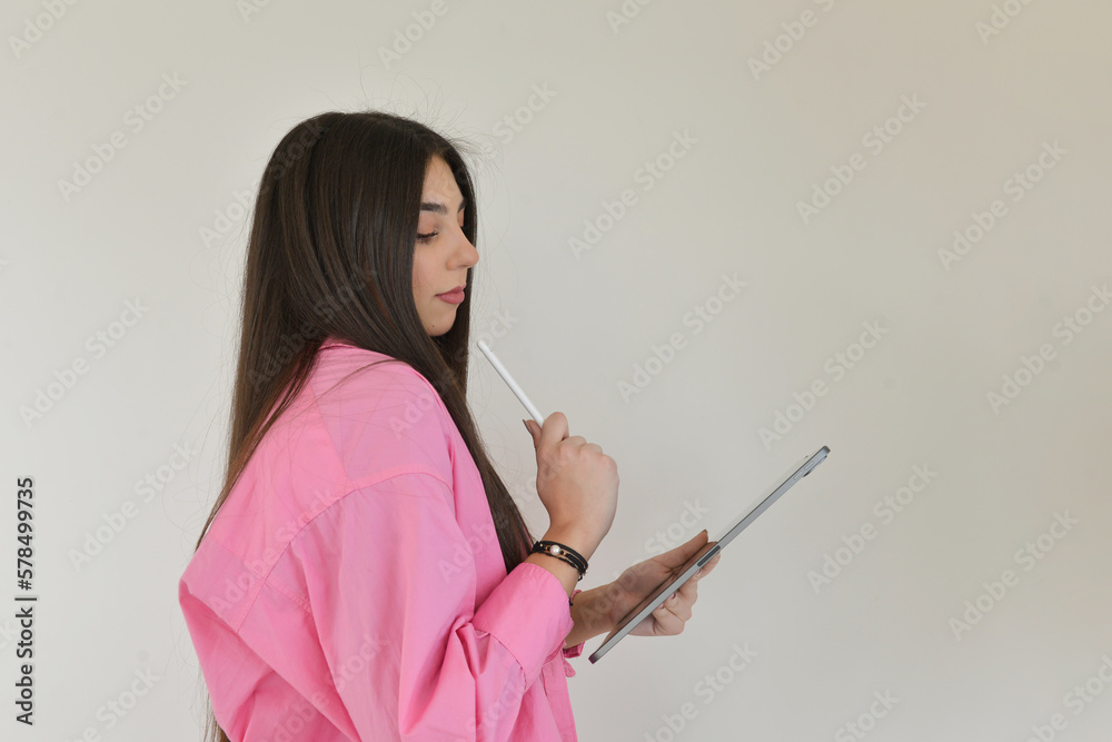 Woman thinking while holding her tablet