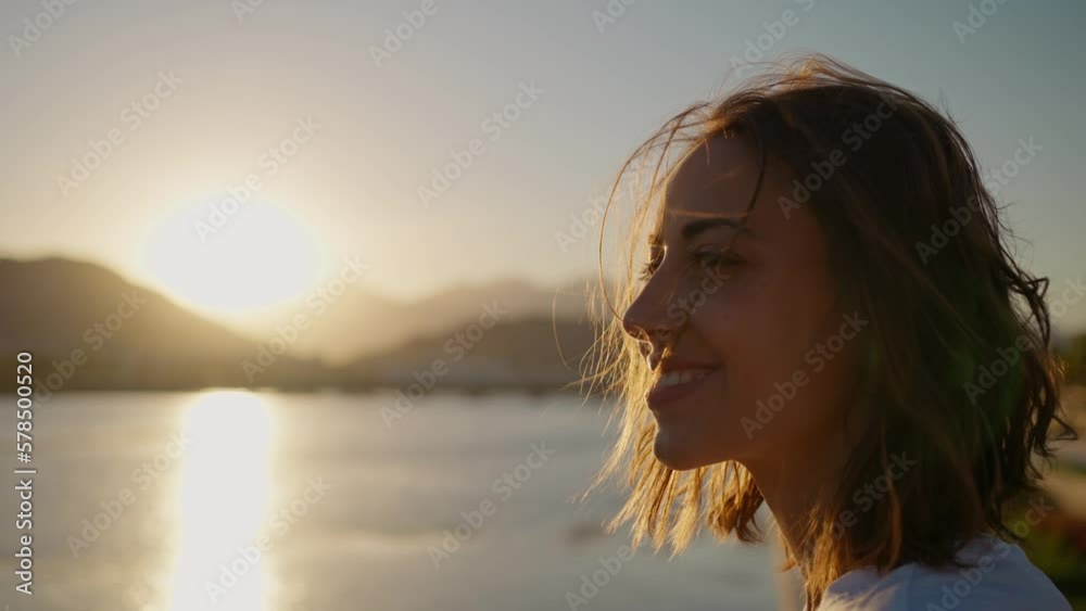 Portrait smiling natural beauty woman looking to camera, enjoying sunset landscape with mountains