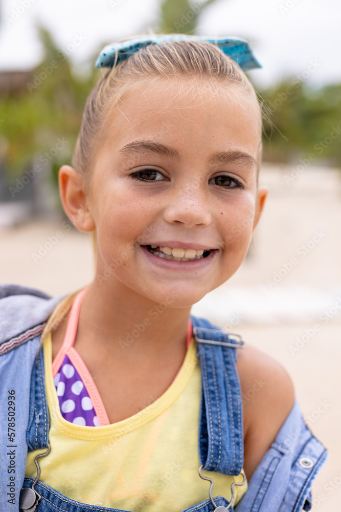 Portrait of happy biracial girl smiling at beach - obrazy, fototapety, plakaty 