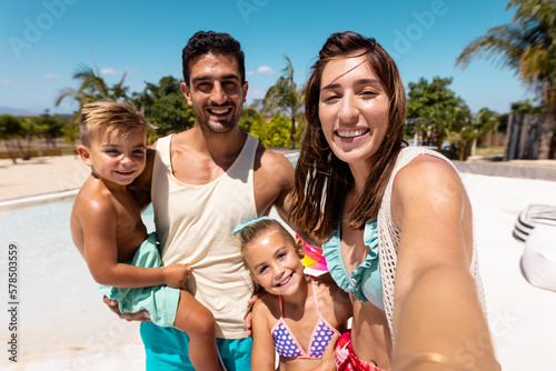Принти на полотні Happy biracial family taking selfie by the swimming pool