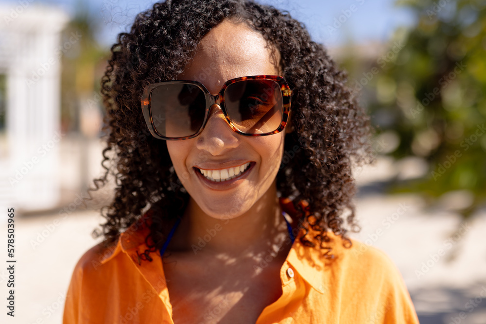 Portrait of happy african american woman looking at camera and smiling at beach Portrait of happy african american woman looking at camera and smiling at beach