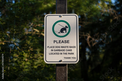 Sign please place dog waste bags in garbage cans located in the park thank you.