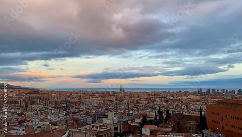 Timelapse during a sunset in Barcelona, looking to Badalona. Aerial view of a time lapse from the Parc del Guinardó with sunset colours, and clouds passing through the sky. North Barcelona timelapse. photo