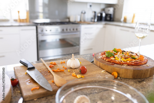 Close up of countertop in kitchen with pizza and wooden boards photo