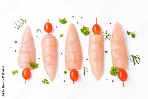 Skewers raw meat and vegetables.Top view.Chicken Skewers breast fillet meat.Raw chicken inner on skewers with tomatoes white background with spices, herbs.Raw uncooked Chicken meat,kebab on skewers. photo