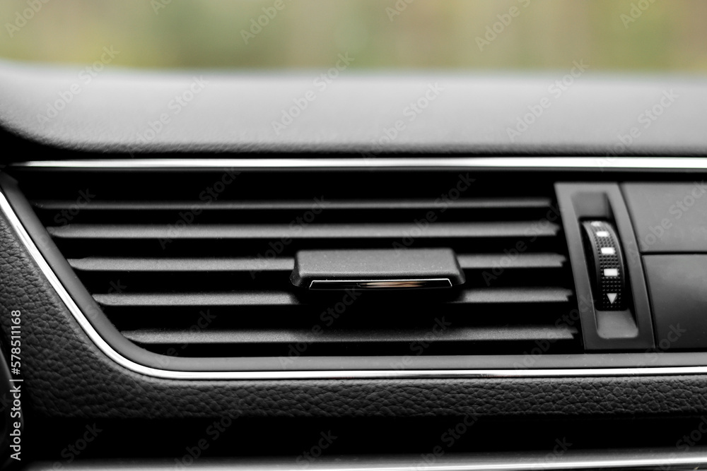 Air conditioner flow inside the car, plastic grid panel. Vehicle air conditioning close up view. Detail interior of modern car. Air ducts. Dashboard
