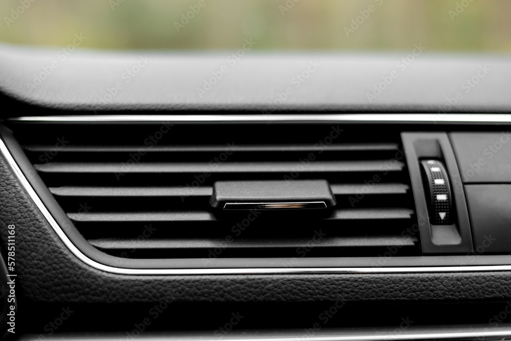 Air conditioner flow inside the car, plastic grid panel. Vehicle air conditioning close up view. Detail interior of modern car. Air ducts. Dashboard Air conditioner flow inside the car, plastic grid panel. Vehicle air conditioning close up view. Detail interior of modern car. Air ducts. Dashboard