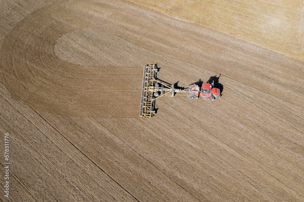 A tractor in the field sows the ground with grain. Agriculture, sowing grain. A tractor in the field sows the ground with grain. Agriculture, sowing grain.