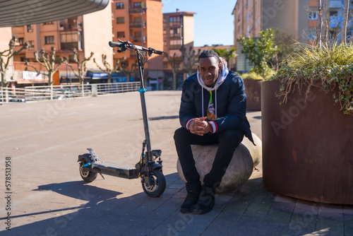Black ethnic male skateboarding on an electric skate, new youth mobility