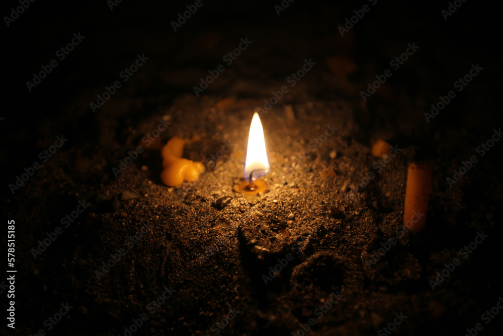 Fotografija The flame of a burning church candle lit up in the darkness