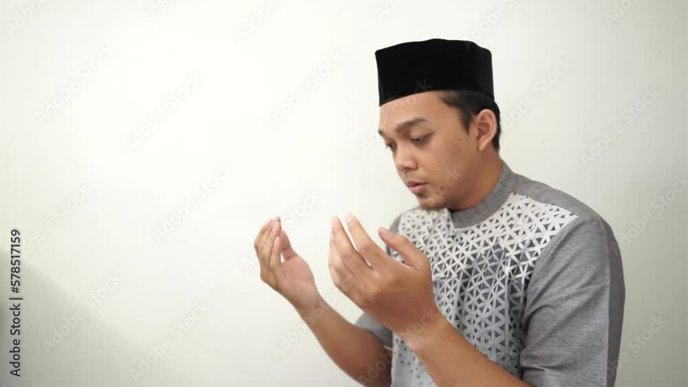 Indonesia Asian muslim men praying gesture wears black peci or songkok