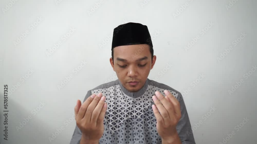 Indonesia Asian muslim men praying gesture wears black peci or songkok