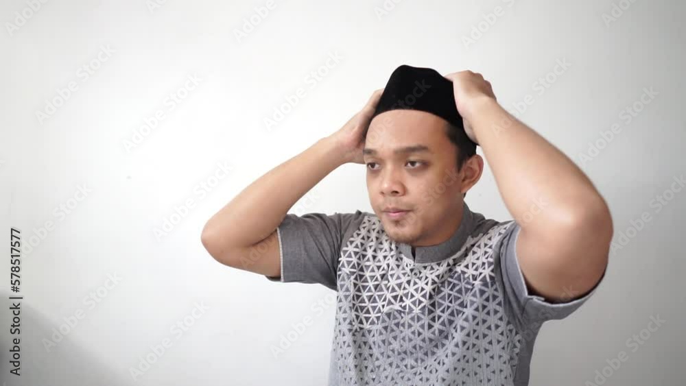 Indonesian Asian muslim man smiling wears black hat called peci or songkok