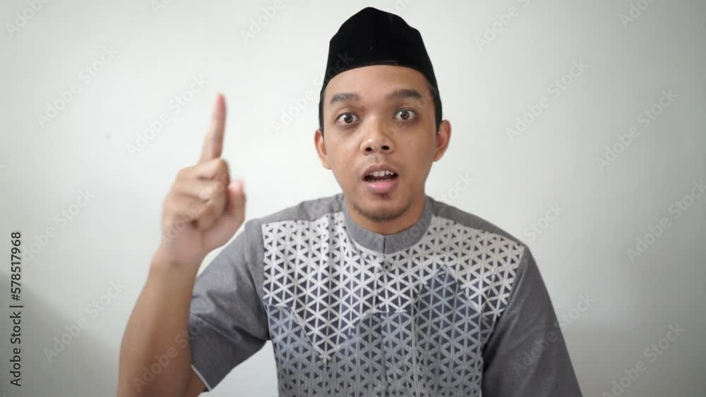 Indonesian Asian muslim man speaking and angry gesture wears black hat peci or songkok