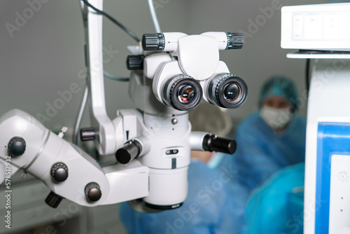 Surgical microscope in operating room with doctors. Ophthalmological clinic. Microsurgical optical equipment