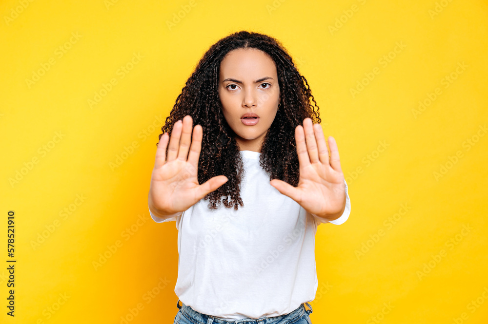 Brazilian or hispanic woman show to the camera gesture STOP. Struggle