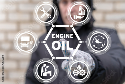 Mechanic or worker using virtual touch screen presses inscription: ENGINE OIL. Concept of engine lubricant oil. Motor oil replacement maintenance car service. Oil and lubricants industry production.