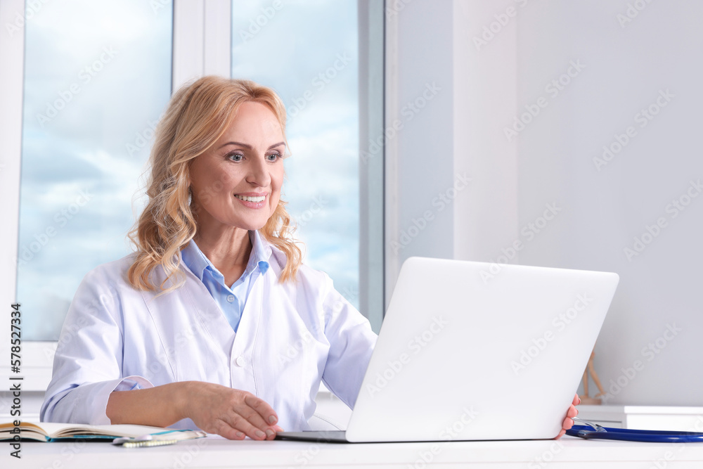 Doctor with laptop consulting patient in clinic. Online medicine concept Doctor with laptop consulting patient in clinic. Online medicine concept