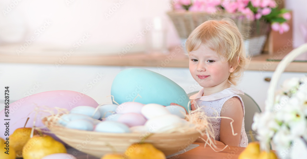 A small kid holds a large colored Easter egg in his hands. Easter card with copy space A small kid holds a large colored Easter egg in his hands. Easter card with copy space