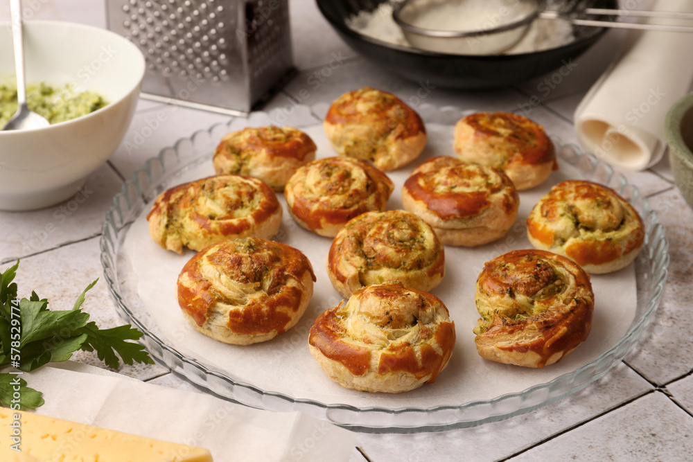 Fresh delicious puff pastry and ingredients on white tiled surface, closeup