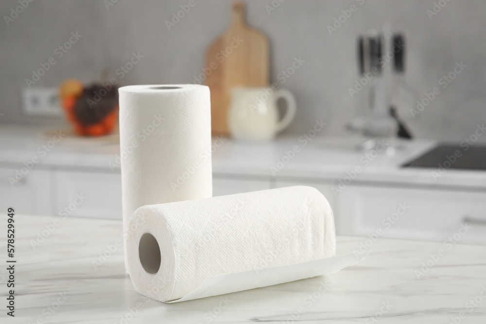 Naklejka premium Rolls of paper towels on white marble table in kitchen