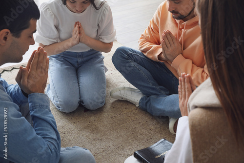 Group of people praying wit...