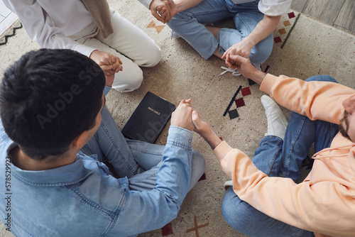 Group of people praying wit...