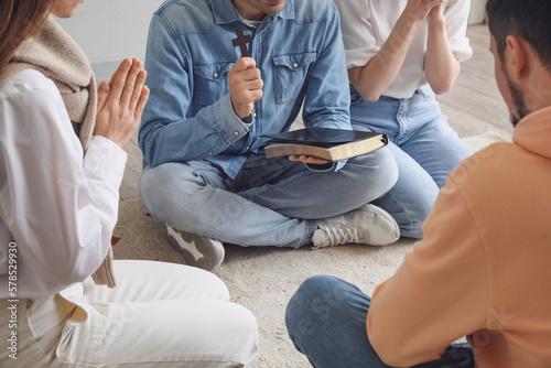 Group of people praying wit...