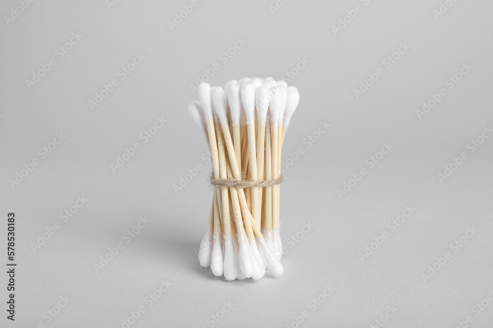 Bunch of wooden cotton buds on light grey background Bunch of wooden cotton buds on light grey background