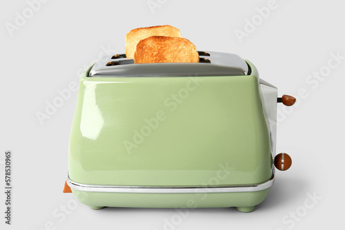 Modern toaster with crispy bread slices isolated on white background