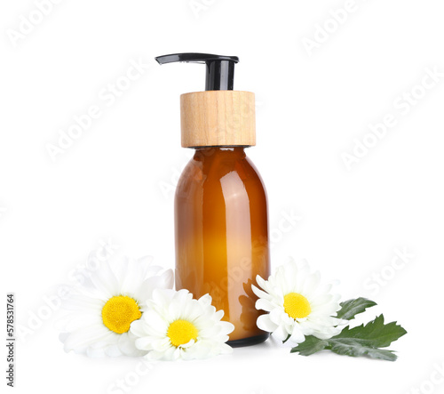 Bottle of cosmetic product and chamomile flowers on white background