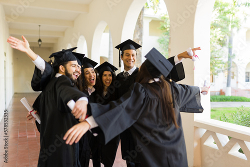 Group of friends celebrating laughing during graduation