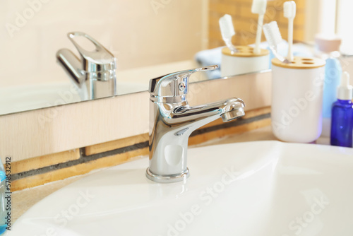 Fototapeta Naklejka Na Ścianę i Meble -  White ceramic sink near mirror, closeup