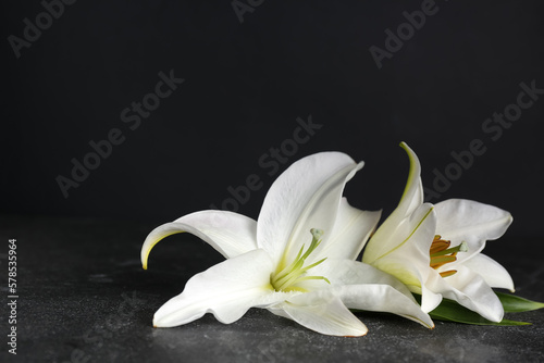 Fototapeta Naklejka Na Ścianę i Meble -  White lily flowers on dark table