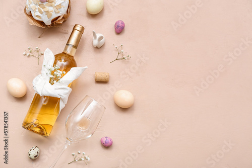 Photography Composition with bottle of wine, glass and Easter eggs on color background