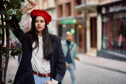 Woman model stands on the street in the city in a jacket and red beret, cinematic french fashion style clothing, travel to istanbul