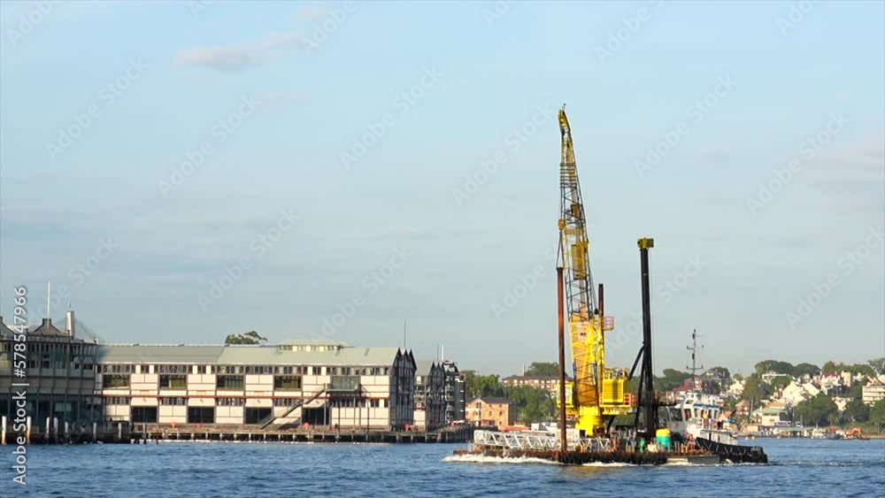 A construction crane ship passes by in Sydney Harbour Australia A construction crane ship passes by in Sydney Harbour Australia