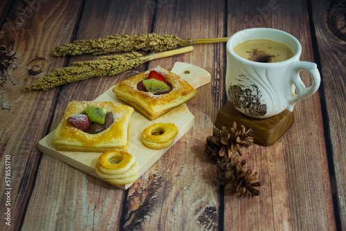sweet pastry filled with fruits and a cup of coffee 