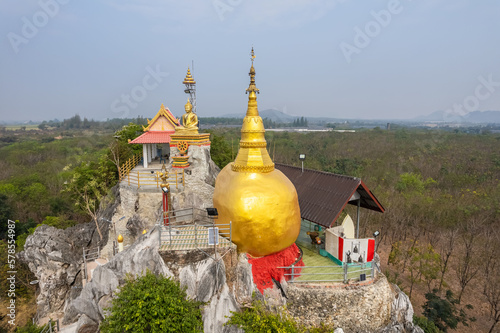 The gold rock that mocks from Kyaiktiyo Pagoda at Tham Champathong monastery, Ratchaburi, Thailand photo