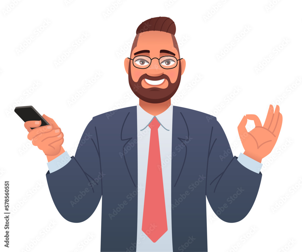 Businessman with glasses holds a smartphone in his hand and shows an OK sign. Advertising of a mobile application or services, promotion of an application or website. Businessman with glasses holds a smartphone in his hand and shows an OK sign. Advertising of a mobile application or services, promotion of an application or website.