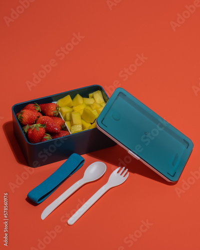 food container with strawberries and sliced ​​pineapple