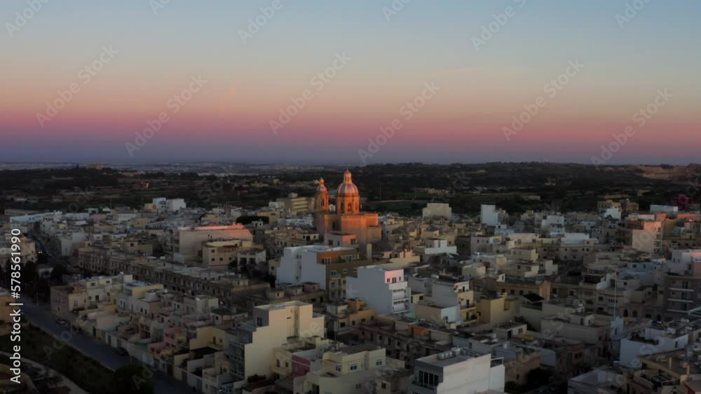 Flying Towards St. Mary's Parish Church At Sunset In Dingli, Malta - drone shot Flying Towards St. Mary's Parish Church At Sunset In Dingli, Malta - drone shot
