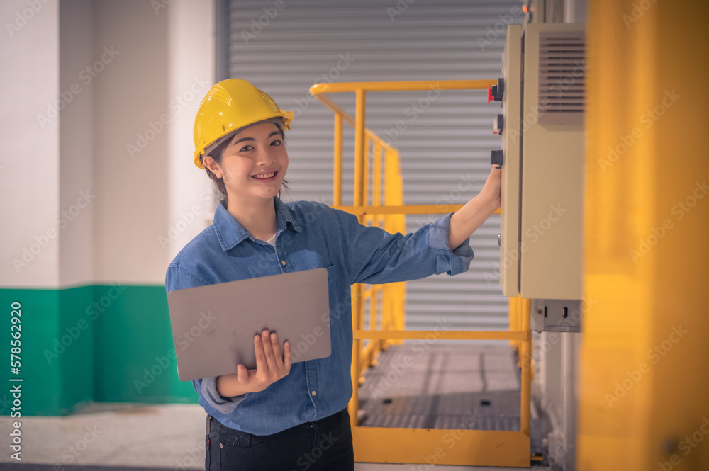 Asian woman Engineer using computer working in factory Asian woman Engineer using computer working in factory
