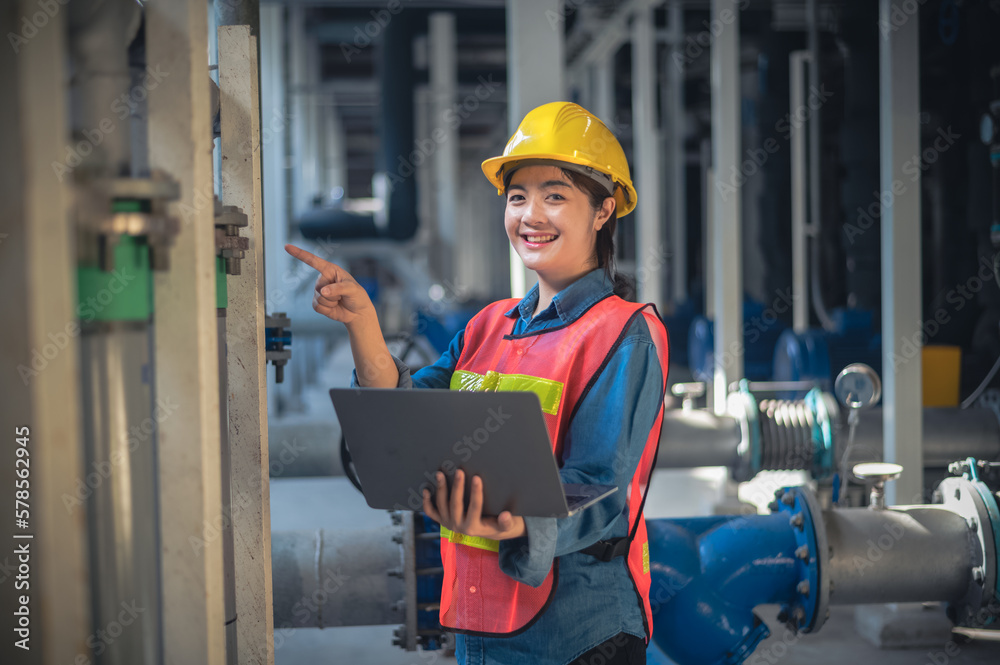 Asian woman Engineer using computer working in factory Asian woman Engineer using computer working in factory