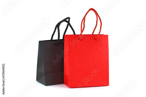 Black and red paper shopping bags over a white