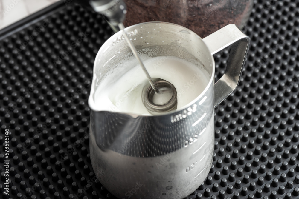 Naklejka premium making froth milk