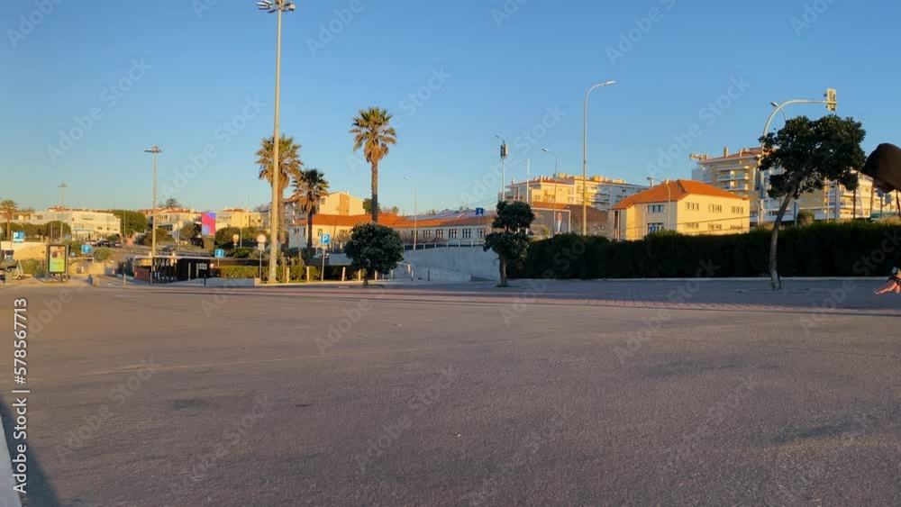 Excited man carving skate park in estoril street on summer day. Slow motion of cheerful male skateboarder with hood doing tricks, practicing professional skills. Extreme sport Excited man carving skate park in estoril street on summer day. Slow motion of cheerful male skateboarder with hood doing tricks, practicing professional skills. Extreme sport