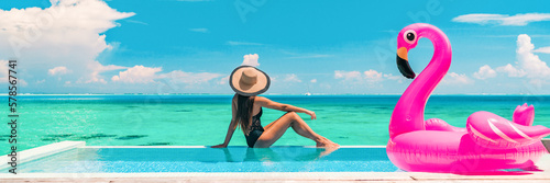 Vacation swimming pool banner luxury travel background woman relaxing by infinity overwater bungalow with pink flamingo float fun holiday concept panorama © Maridav