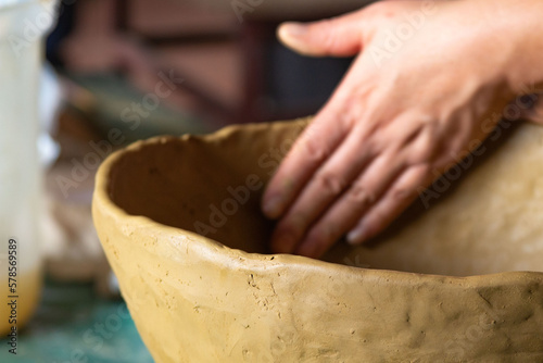 hands of an Atacameño woman shaping the clay in the town of Toconce